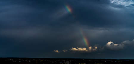 Rainbow in the dark sky.