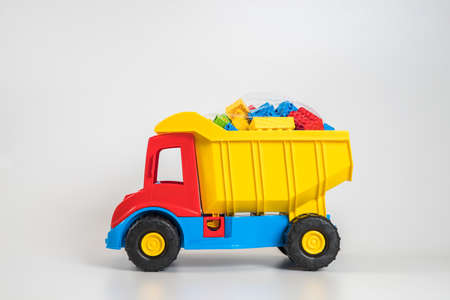 Multi-colored plastic children's toy cars on a white background.の写真素材
