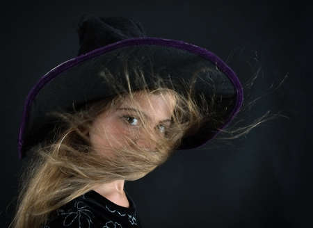 A girl dressed as a witch and a wide-brimmed hat for Halloween.の写真素材