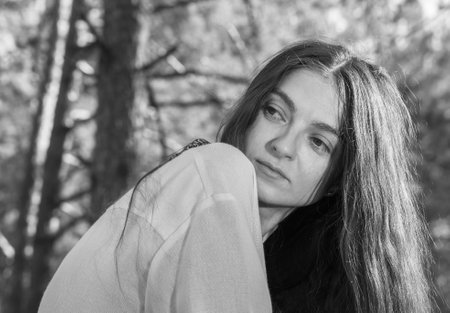Long-haired Ukrainian girl in an embroidered national shirt in the forestの写真素材