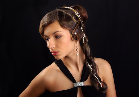 Portrait of a woman on a black background with a retro hairstyle. Beautiful woman. Photo in vintage style.の写真素材