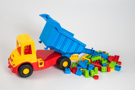 Multi-colored plastic children's toy cars on a white background.の写真素材