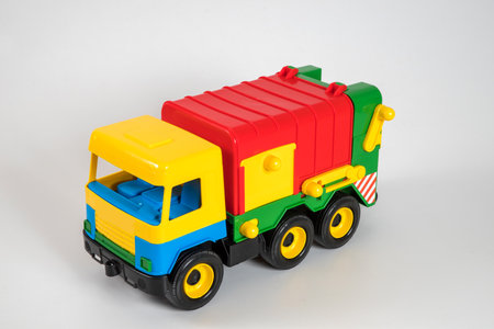 Multi-colored plastic children's toy cars on a white background.の写真素材