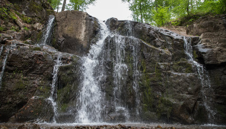 Jets of a waterfall among the stonesの写真素材