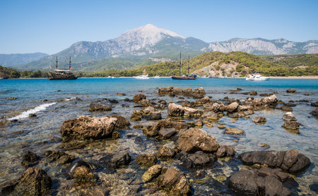 Tekirova, Turkey September 9, 2020 Pleasure yacht in the sea bay against the backdrop of mountainsのeditorial素材