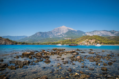 Tekirova, Turkey September 9, 2020 Pleasure yacht in the sea bay against the backdrop of mountainsのeditorial素材