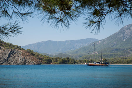 Tekirova, Turkey September 9, 2020 Pleasure yacht in the sea bay against the backdrop of mountainsのeditorial素材