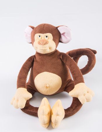 Plush children's toy monkey on a white background.の写真素材