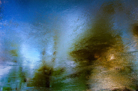 Multicolored reflections of trees in water. Abstract texture of water.の写真素材