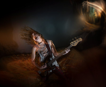 A female rocker with gothic makeup performing metal music during Halloweenの写真素材