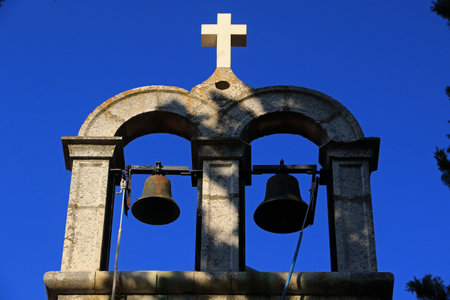 Church bells against the blue sky, Church of St. John and Paul in Humac, ghost village, abandoned village on Hvar island, Croatiaの写真素材