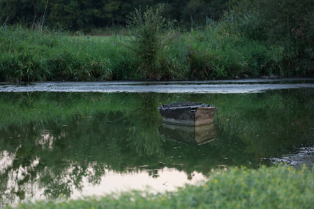 Boat on the river bank in the evening. Summer landscape. Wooden boatの写真素材