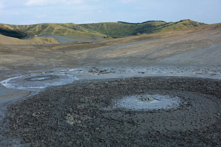 Bubble of gas bursting through the mouth of active Mud Volcano in Berca Mud Volcanoes area, Romania