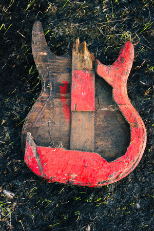 Image electric guitar, which was burned down, on the burned ground.の写真素材