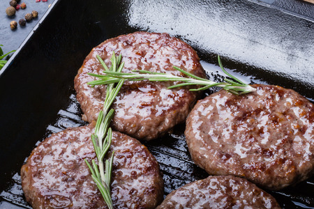 Beef roasted cutlets on grill pan with rosemary and seasoningsの写真素材