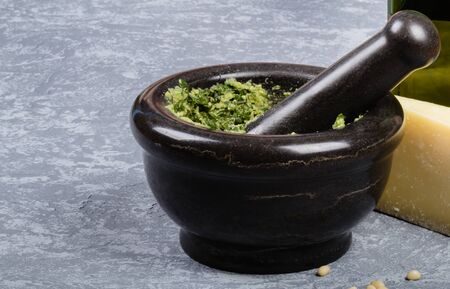 Mortar with pesto on grey backgroundの写真素材