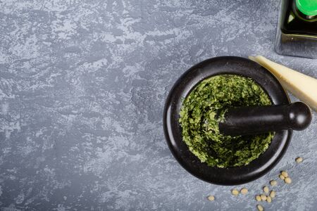 Prepared pesto in the mortar on grey background with space for recipe. Top viewの写真素材