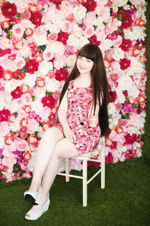 one young girl on the flowers backgroundの写真素材