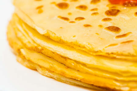 some roasted pancakes on the white plate on white background