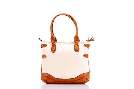 Leather ladies bag on a white background. Beautiful, fashionable, accessory, isolated. Interesting design, the texture of the skin. Comfortable handle.の写真素材