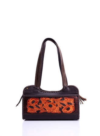 Leather ladies bag on a white background. Beautiful, fashionable, accessory, isolated. Interesting design, the texture of the skin. Comfortable handle.の写真素材