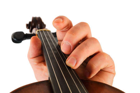 Image violin lies in a human hand.String instrument isolated on white background.Fingers play musicの写真素材