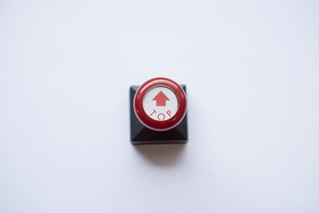 stamp with red handle, arrow and top words isolated on whiteの写真素材