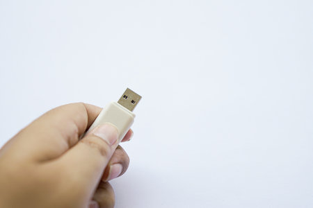 human hand on used flash drive is white, Compact USB drive, Close-up of flash memory template...