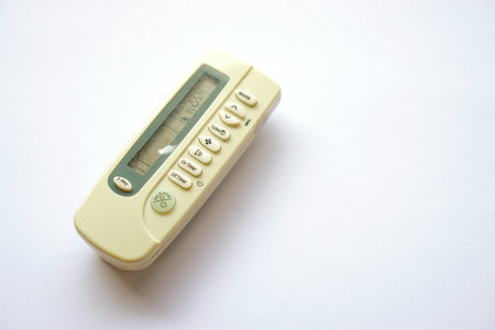 used remote air conditioner until it turns yellow isolated on white