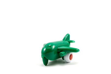 Green paint plastic toy airplane isolated on white backgroundの写真素材