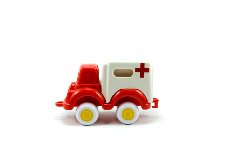 red paint plastic toy ambulance car isolated on white backgroundの写真素材