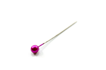 pink sewing straight pin isolated on whiteの写真素材
