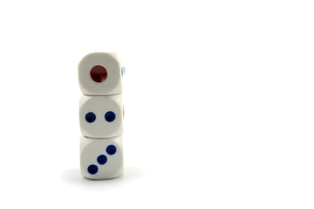 Three plastic dice isolated on a white background, a dice is a small object generally in the shape...