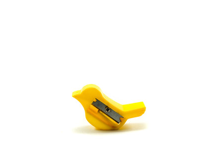 Unique used yellow pencil sharpener in the shape of a bird isolated on white background.の写真素材