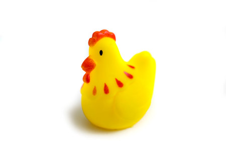 toddler toy yellow rubber chicken playing in bath isolated on white background.の写真素材