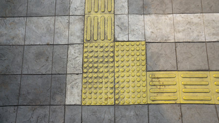 Braille Blocks are plates that are placed on pedestrians to safely guide blind people, so that they can be recognized by the sense of touch of the soles of the feet or sticks.の写真素材