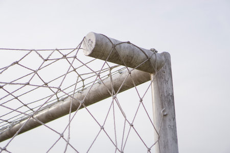 right corner of the soccer goal net with a white sky background.の写真素材