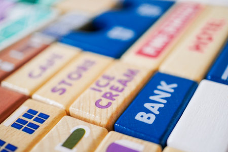 The wooden building blocks are painted colorful and focus on the words bank.