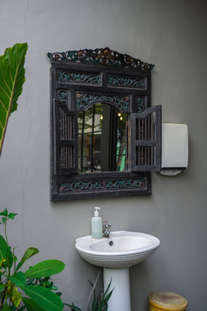 hand washing sink with retro mirror outdoors.