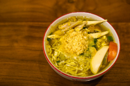 Soto ayam is a typical Indonesian food in the form of a type of chicken soup with a yellowish sauce.の写真素材