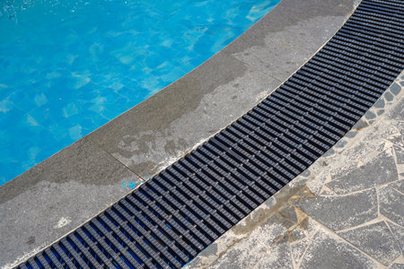edge of the swimming pool with clear water, black pool trellis.の写真素材