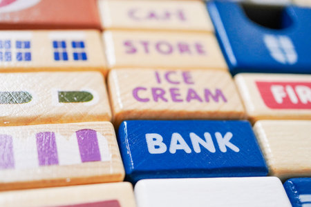 The wooden building blocks are painted colorful and focus on the words bank.