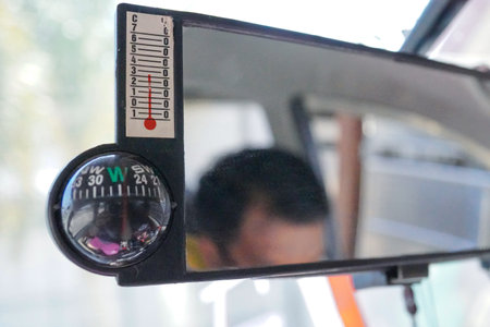 rearview mirror with built-in manual compass in the car.