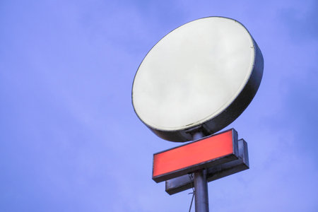 Blank white signboard in circle and rectangle shape at night against blue sky, Mock up,の写真素材