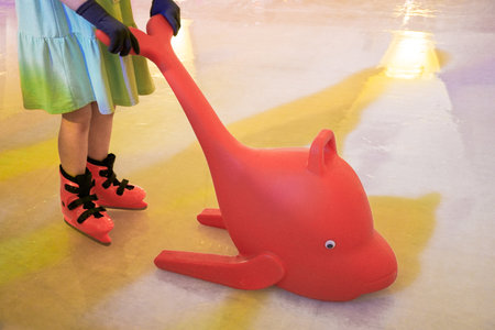 children learn to skate with plastic red dolphin shapes as training aids.の写真素材