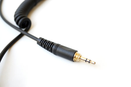 spiral headphone audio jack cable with empty space isolated on white background