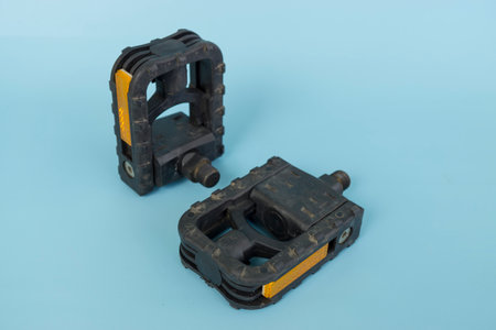 folding bicycle pedals, part of a folding bicycle, isolated on blue background.