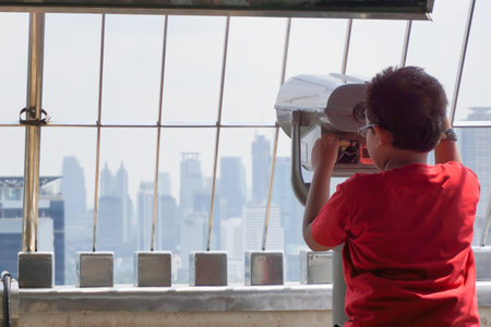 tourist looks through city binoculars. Travel and tourism concept. Discover new places.