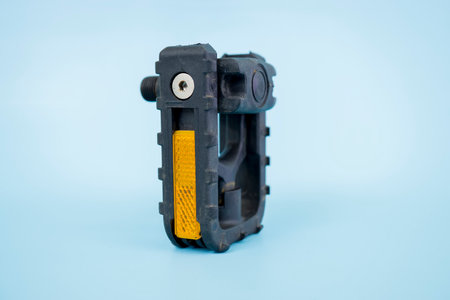 folding bicycle pedals, part of a folding bicycle, isolated on blue background.