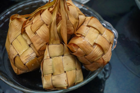 Ketupat Rice Dumpling Special Dish served at Eid Mubarak. Ketupat is Cooked Rice with Young Coconut Leaves Casing Eid al Fitr Moslem Celebration. Popular Malay and indonesian traditional Syawal foodの写真素材